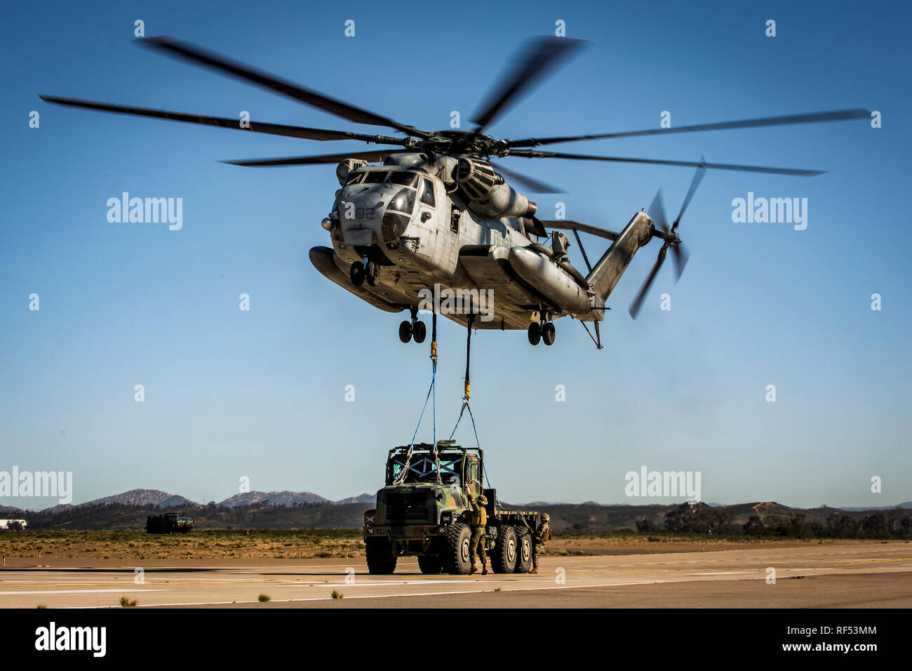 A CH-53E Super Stallion with Marine Heavy Helicopter Squadron 361, 3rd Marine Aircraft Wing, lifts a Medium Tactical Vehicle Replacement truck during a Helicopter Support Team (HST) training exercise at Marine Corps Air Station Miramar, California, Jan. 22, 2019. The training was executed to employ an HST and CH-53E Super Stallion to lift a Medium Tactical Vehicle Replacement truck for transportation. (U.S. Marine Corps photo by Lance Cpl. Betzabeth Y. Galvan) Stock Photo