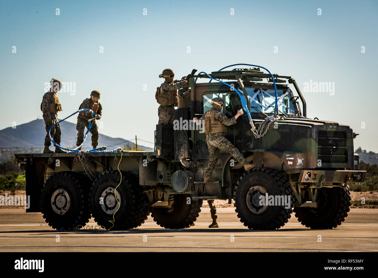 U.S. Marines with 1st Transportation Support Battalion, 1st Marine Logistics Group, prepare to conduct a Helicopter Support Team (HST) training exercise at Marine Corps Air Station Miramar, California, Jan. 22, 2019. The training was executed to employ an HST and CH-53E Super Stallion to lift a Medium Tactical Vehicle Replacement truck for transportation. (U.S. Marine Corps photo by Lance Cpl. Betzabeth Y. Galvan) Stock Photo