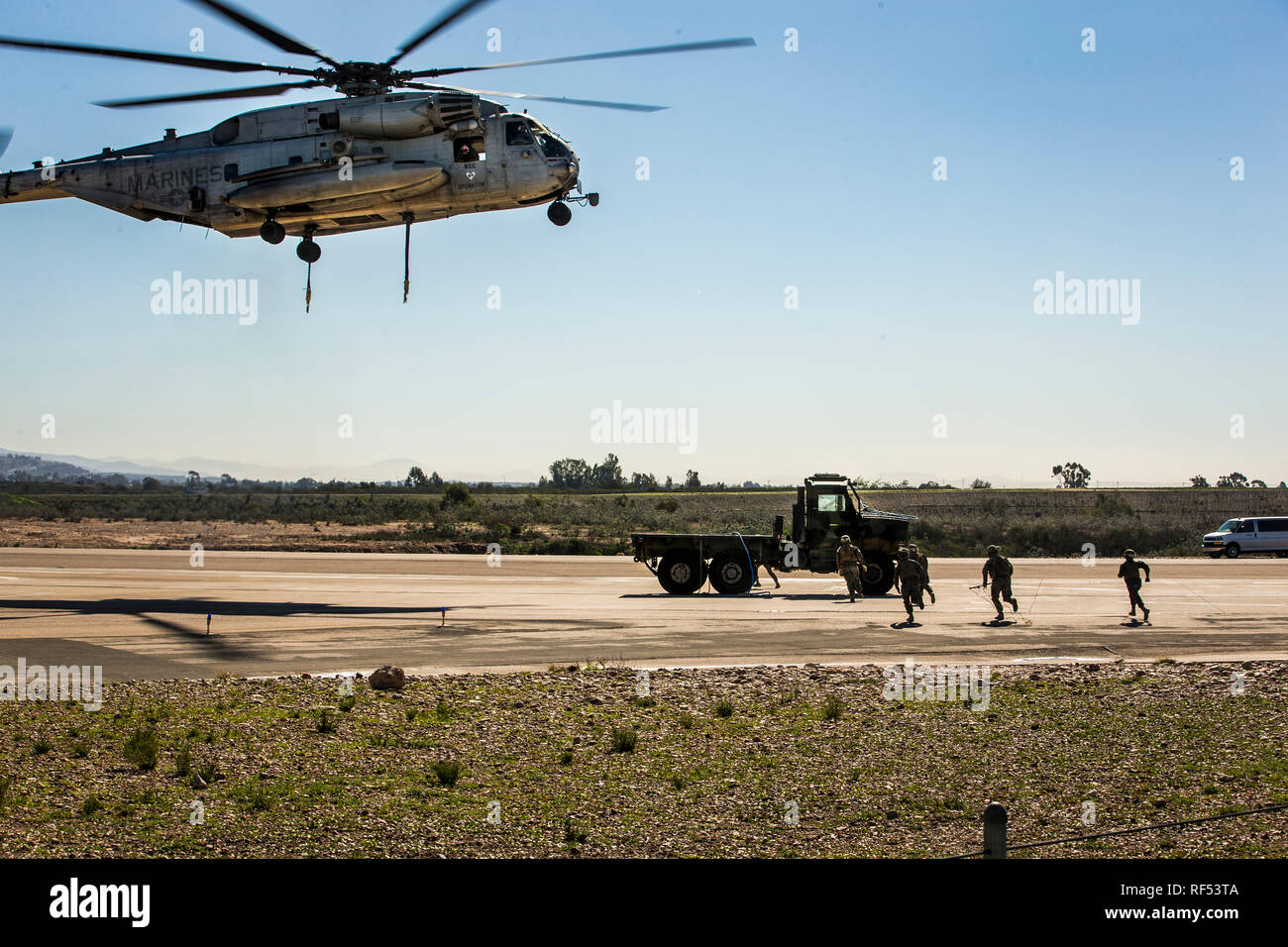 U.S. Marines with Marine Heavy Helicopter Squadron 361, 3rd Marine Aircraft Wing, conduct a Helicopter Support Team (HST) training exercise with 1st Transportation Support Battalion, 1st Marine Logistics Group at Marine Corps Air Station Miramar, California, Jan. 22, 2019. The training was executed to employ an HST and CH-53E Super Stallion to lift a Medium Tactical Vehicle Replacement truck for transportation. (U.S. Marine Corps photo by Lance Cpl. Betzabeth Y. Galvan) Stock Photo
