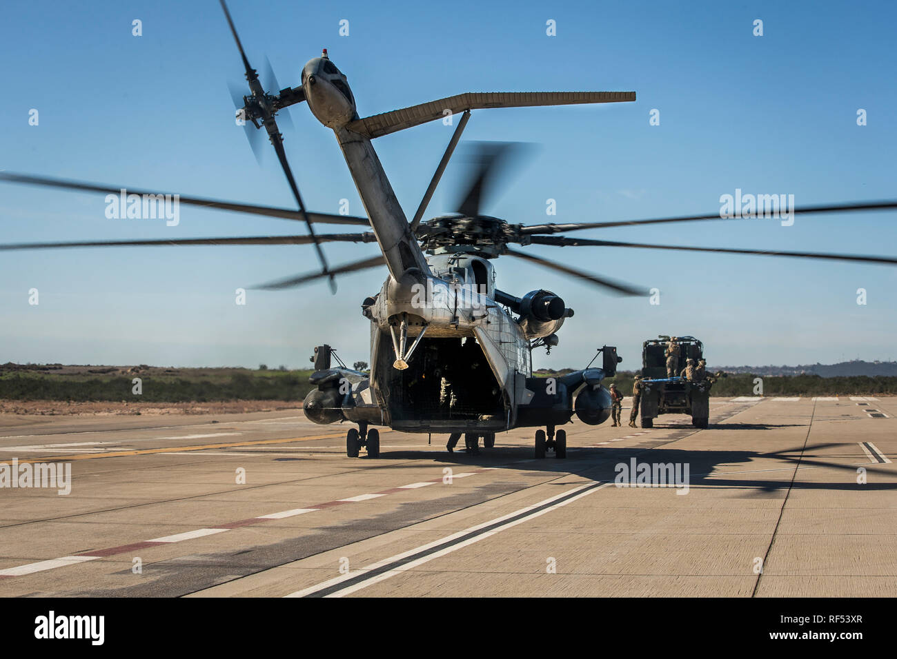U.S. Marines with Marine Heavy Helicopter Squadron 361, 3rd Marine Aircraft Wing, conduct a Helicopter Support Team (HST) training exercise with 1st Transportation Support Battalion, 1st Marine Logistics Group at Marine Corps Air Station Miramar, California, Jan. 22, 2019. The training was executed to employ an HST and CH-53E Super Stallion to lift a Medium Tactical Vehicle Replacement truck for transportation. (U.S. Marine Corps photo by Lance Cpl. Betzabeth Y. Galvan) Stock Photo