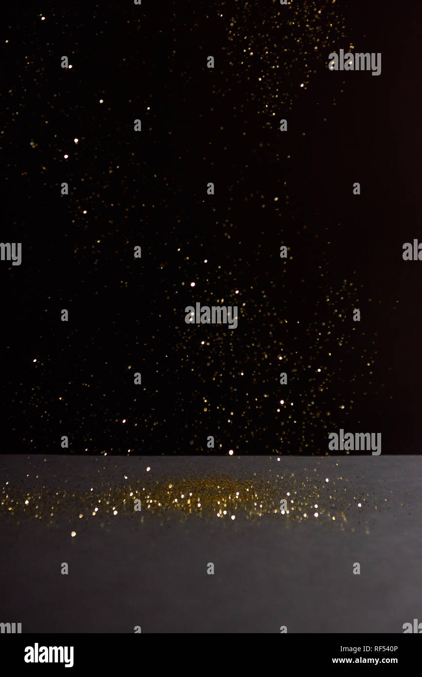 grey stone table with bright sparkles isolated on black Stock Photo