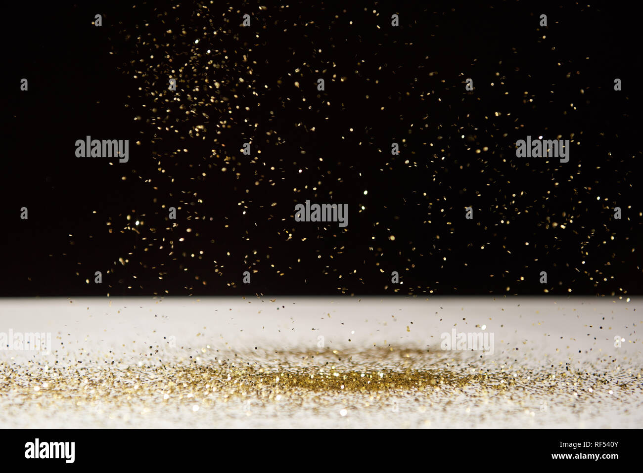 white table with bright sparkles isolated on black Stock Photo