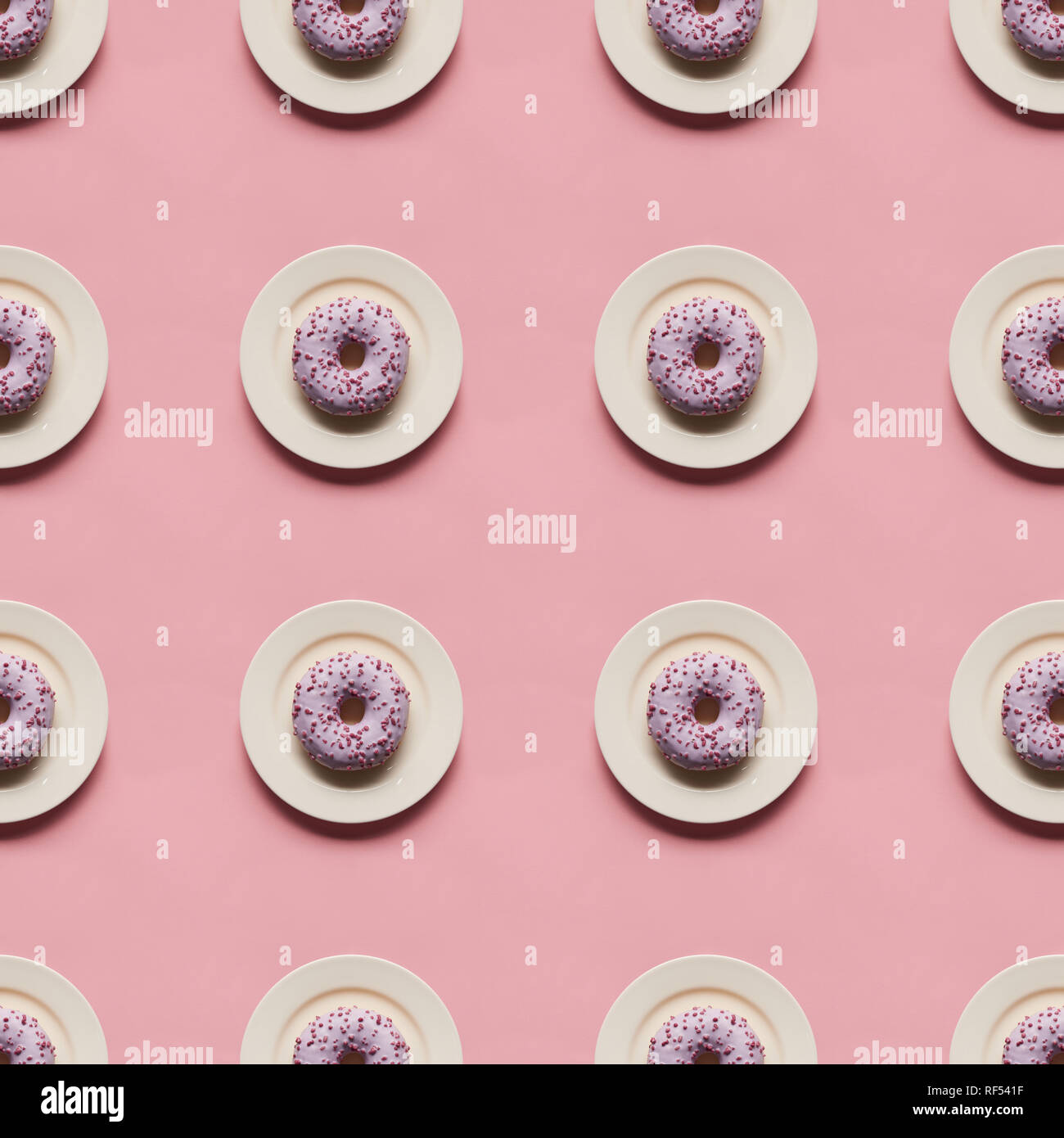 top view of sweet glazed donuts in plates isolated on pink Stock Photo ...