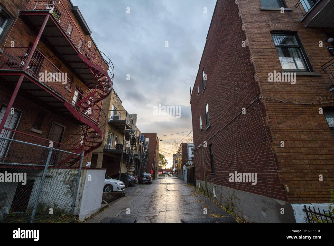 MONTREAL, CANADA - NOVEMBER 6, 2018: Dilapidated typical north American residential street in autumn in Montreal, Quebec, during a rainy day, with car Stock Photo