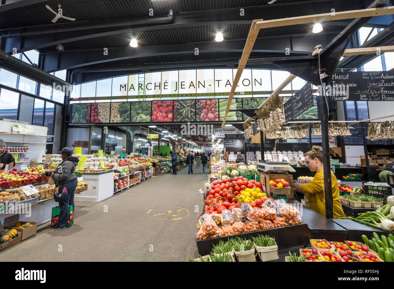 MONTREAL, CANADA - NOVEMBER 6, 2018: Main alley of Marche Jean Talon Market with merchants selling fruits, vegetables and groceries. It is a landmark  Stock Photo