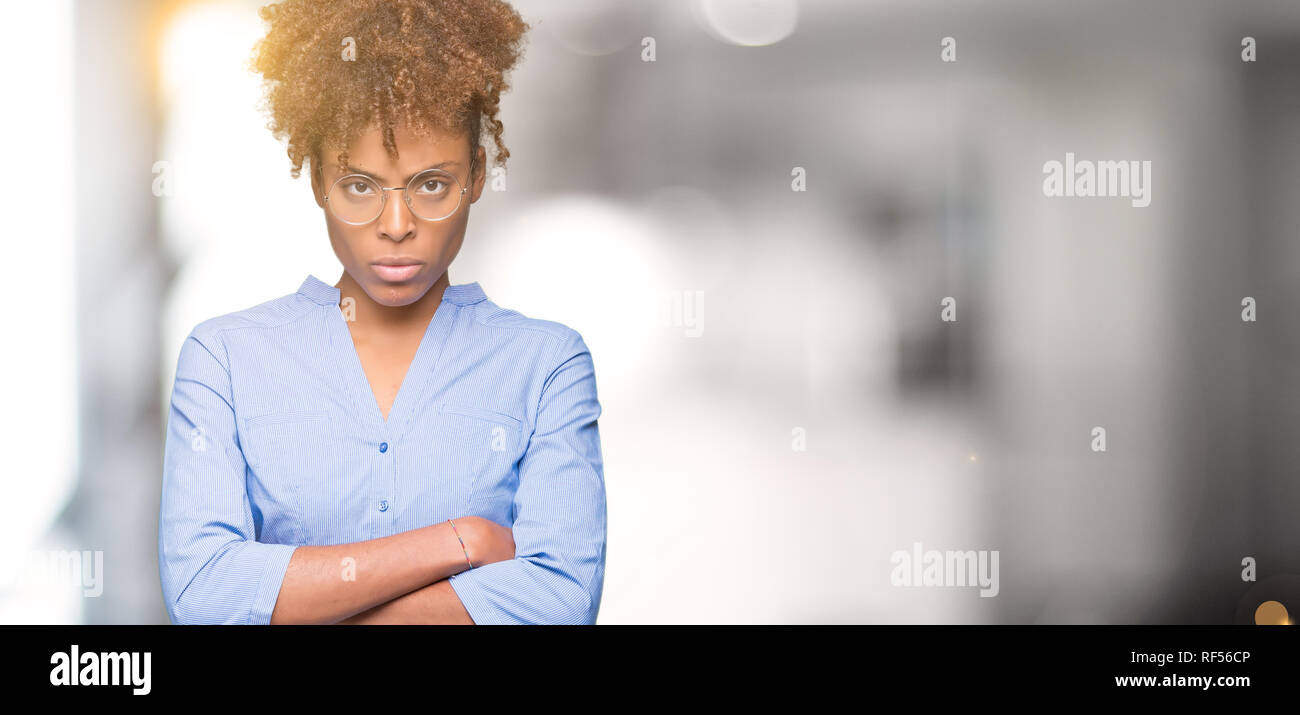 Beautiful young african american business woman over isolated background skeptic and nervous, disapproving expression on face with crossed arms. Negat Stock Photo