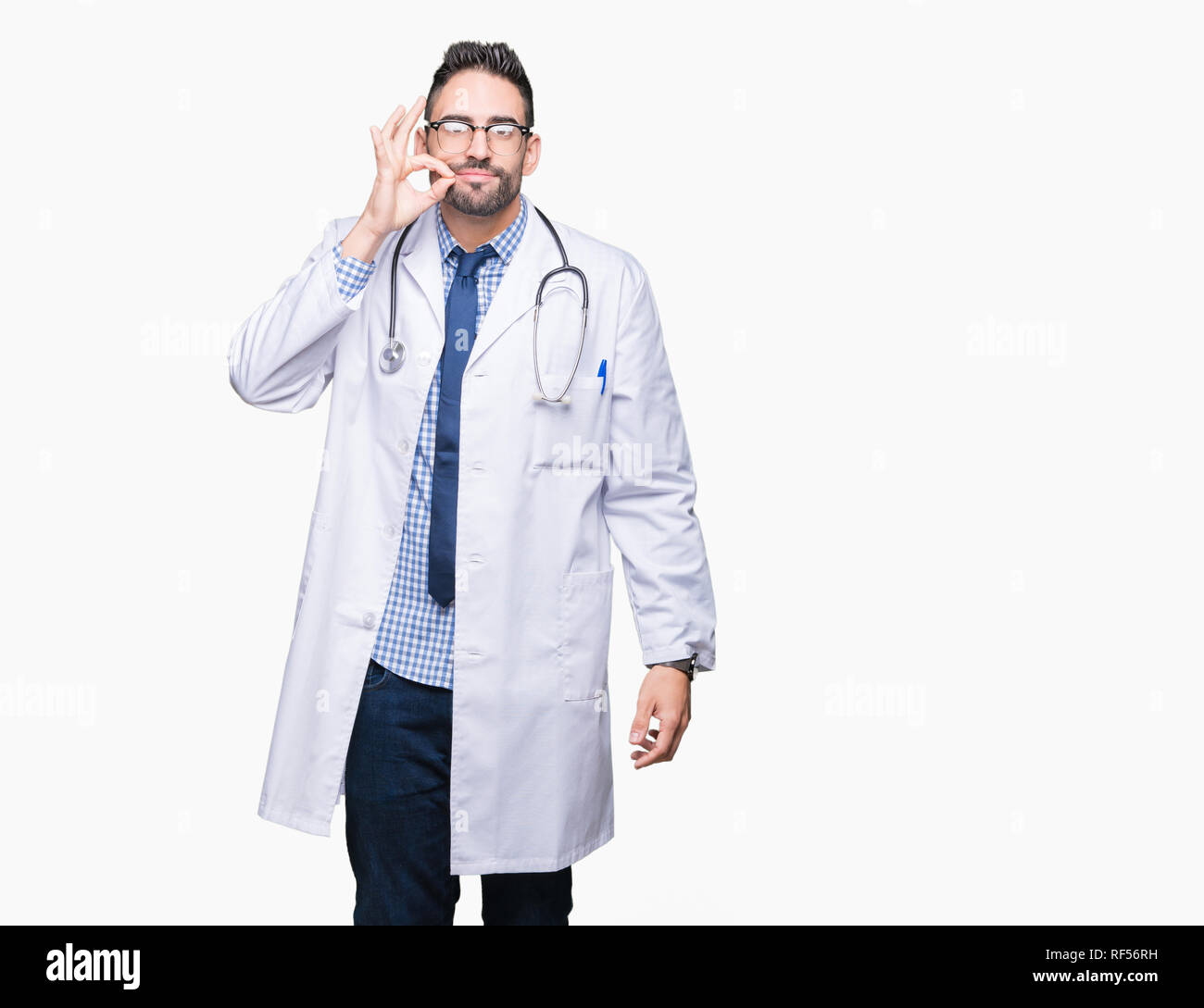 Handsome young doctor man over isolated background mouth and lips shut as zip with fingers. Secret and silent, taboo talking Stock Photo