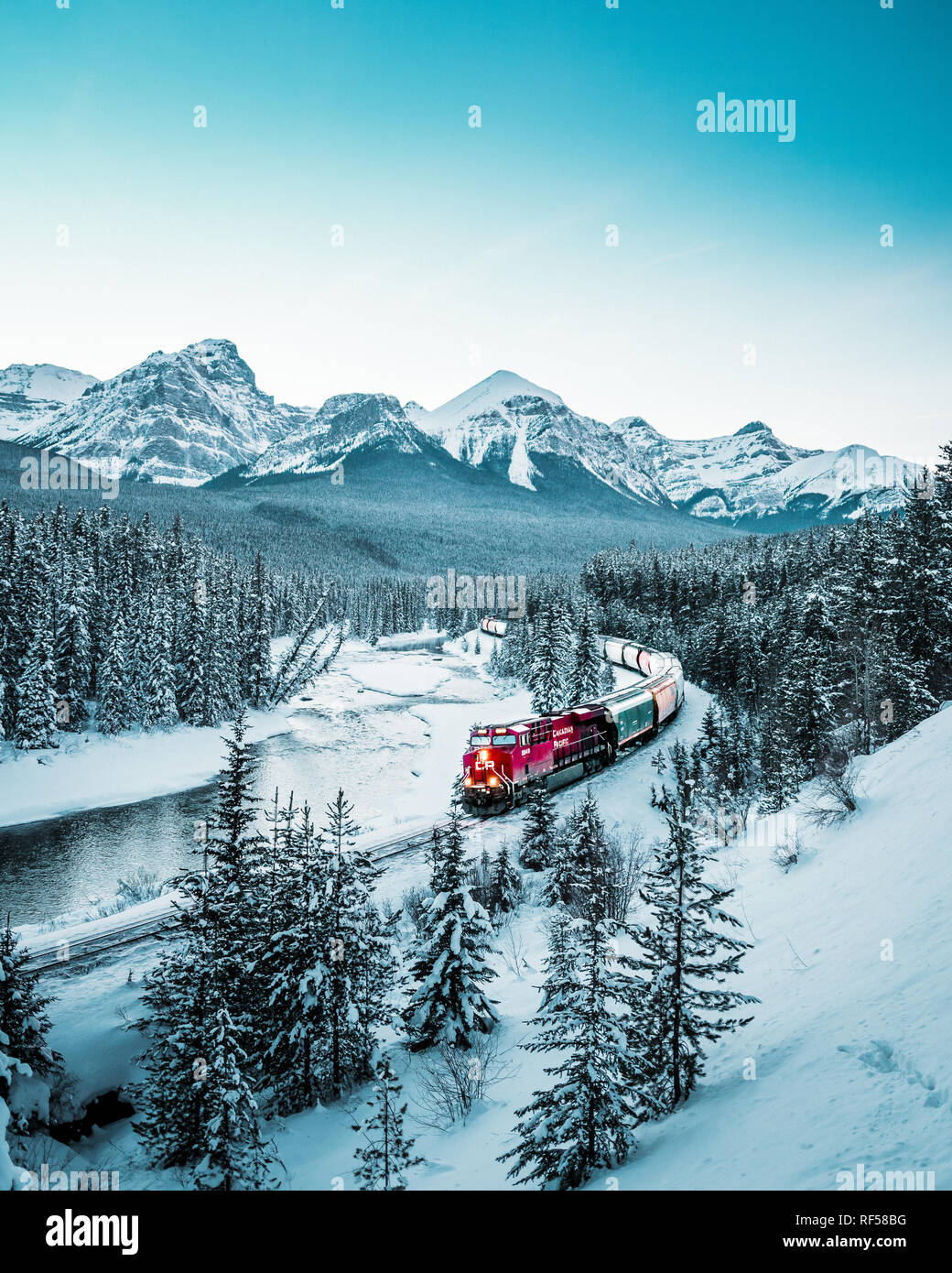 Morant's Curve with train in winter, Banff National Park, AB, Canada Stock Photo