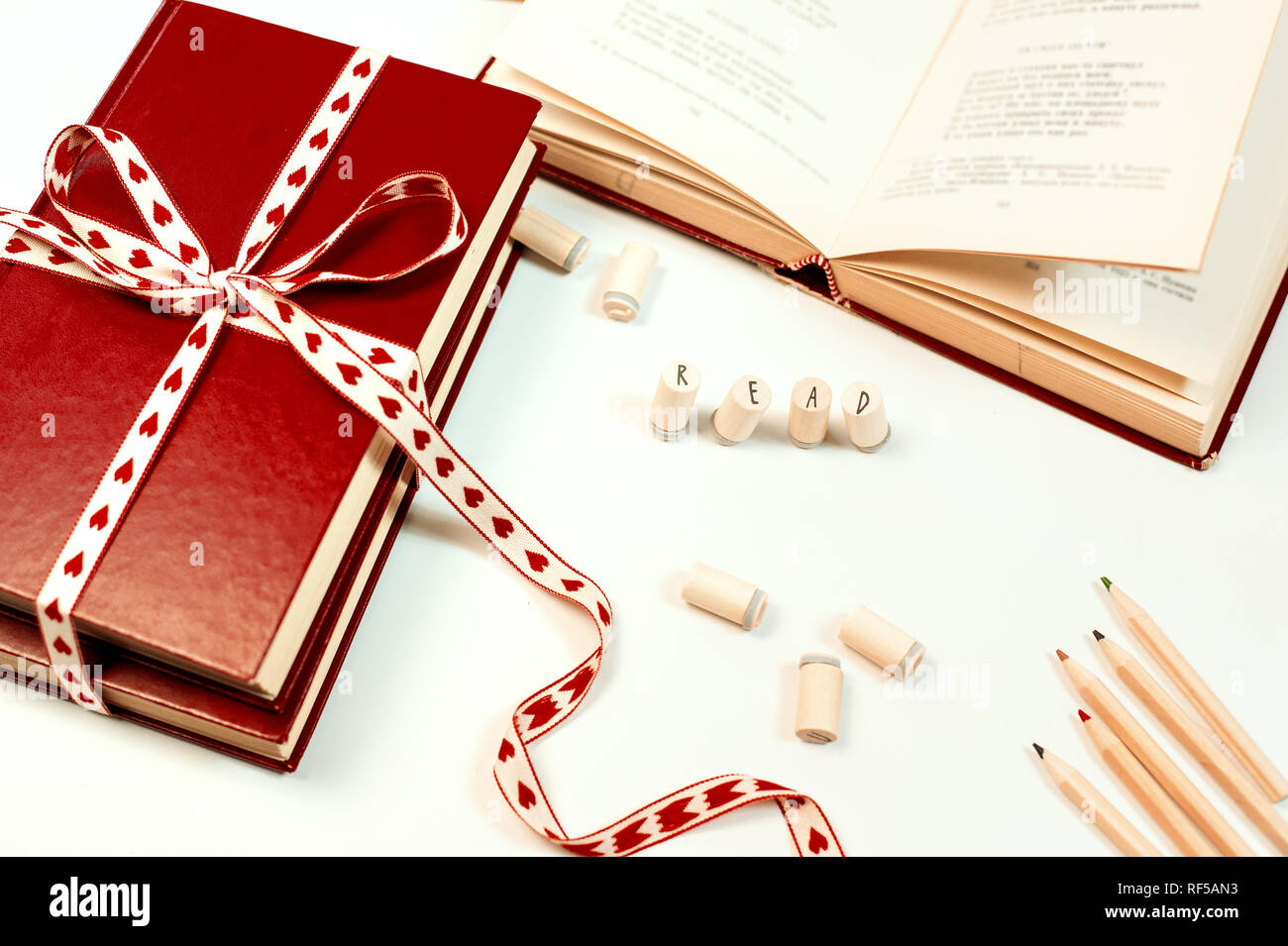 Valentines day background. Stack of books with ribbon Stock Photo