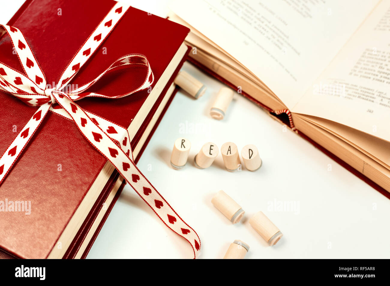 Valentines day background. Stack of books with ribbon Stock Photo - Alamy