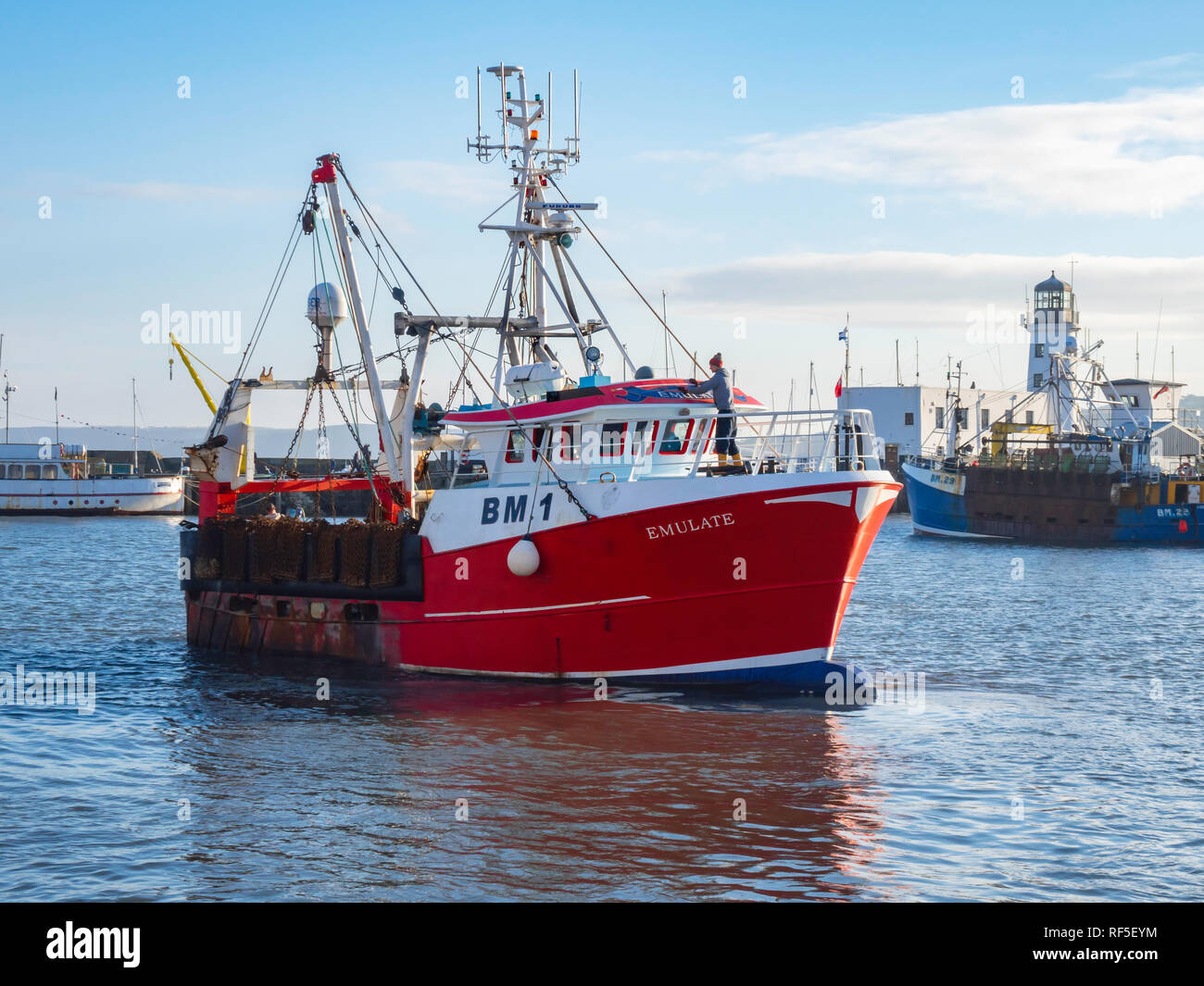 Emulate a scallop fishing boats from Brixham departing from the Fish Quay in Scarborough Harbour North Yorkshire England UK Stock Photo