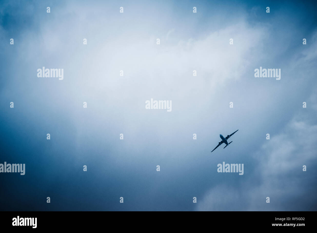 airplane in the sky, blue toned images. Stock Photo