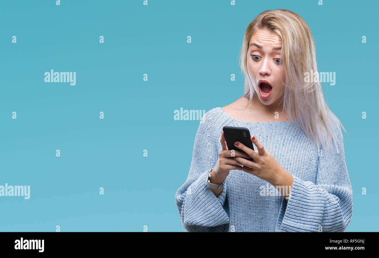 Young blonde woman texting sending message using smartphone over ...