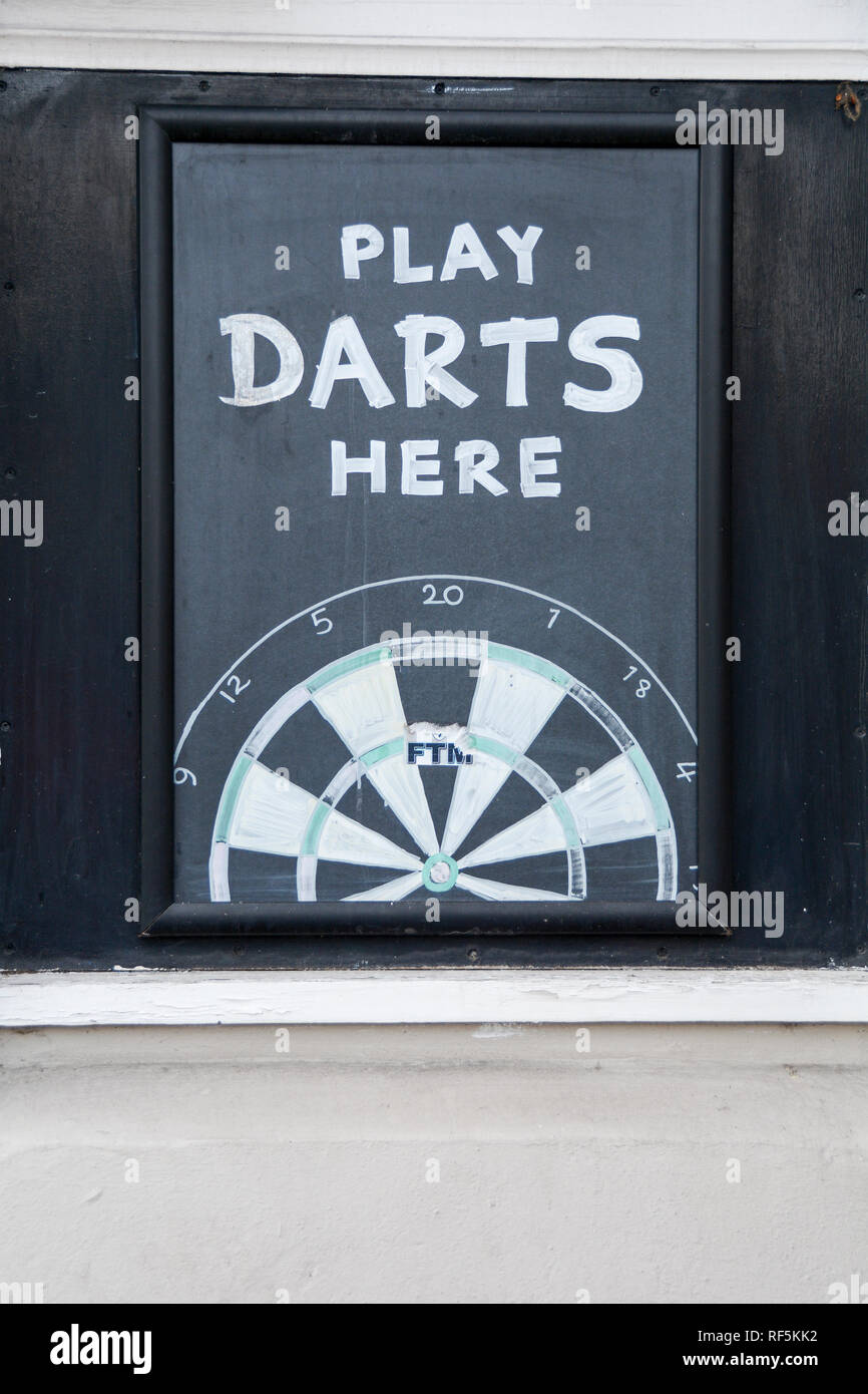 Closeup of a Play Darts Here chalk dart board outside a pub in London, England, UK Stock Photo