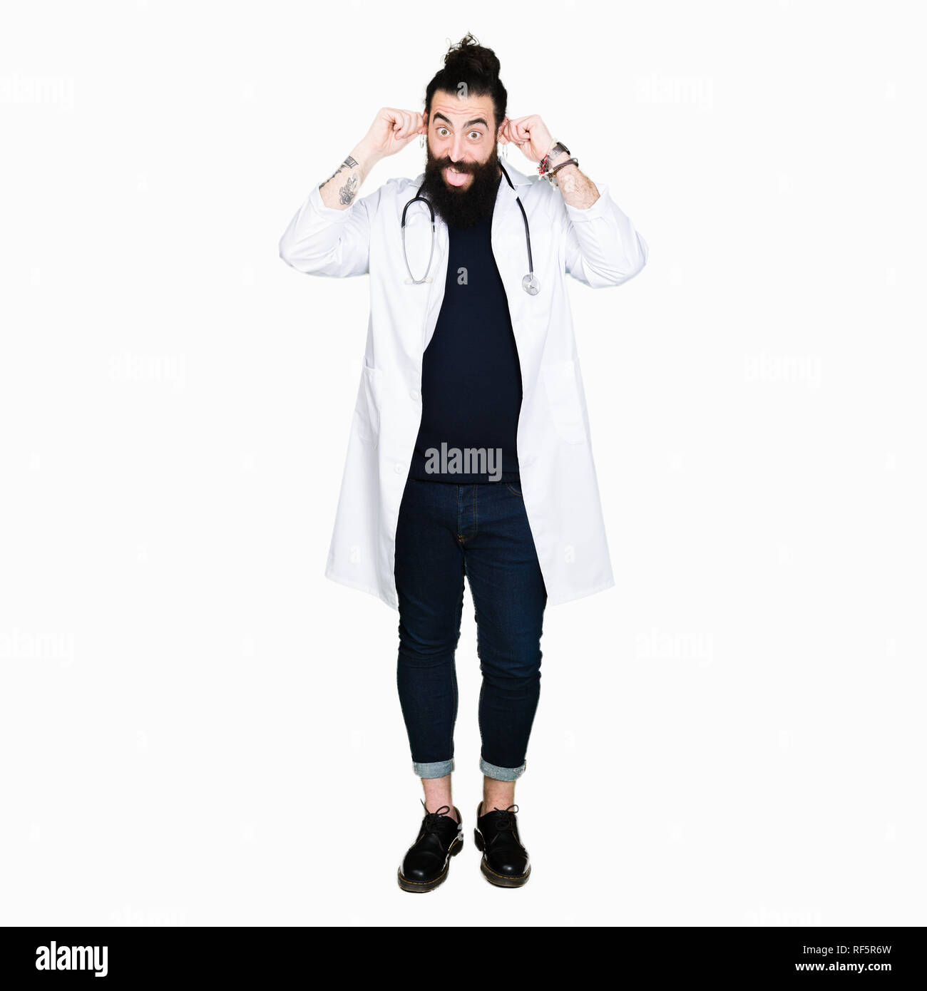 Doctor with long hair wearing medical coat and stethoscope Smiling pulling ears with fingers, funny gesture. Audition problem Stock Photo - Alamy Doctor with long hair wearing medical coat and stethoscope Smiling pulling ears with fingers, funny gesture. Audition problem Stock Photo - Alamy