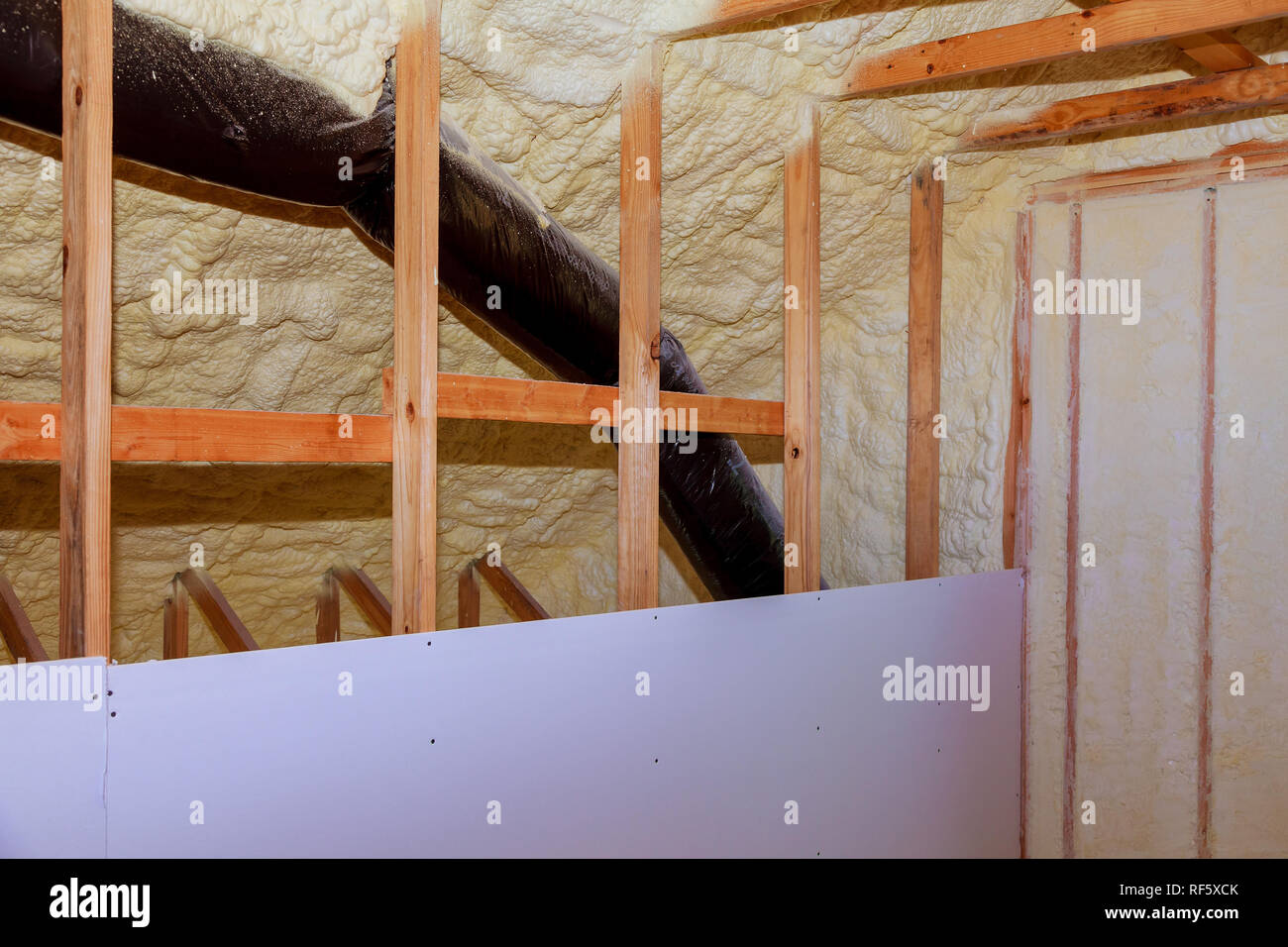 Inside wall insulation in wooden house, building under construction Stock Photo