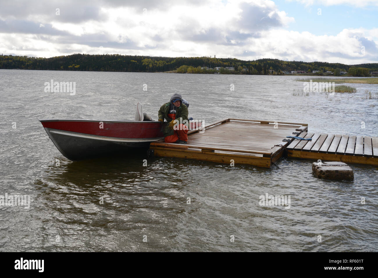 An indigenous wilderness guide at his boat on the Churchill RIver in the Cree First Nation town of Stanley Mission, northern Saskatchewan, Canada. Stock Photo