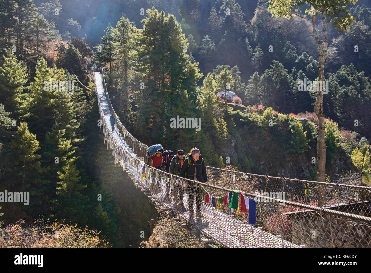 Trekkers crossing a suspension bridge, Everest Base Camp trek, Khumbu