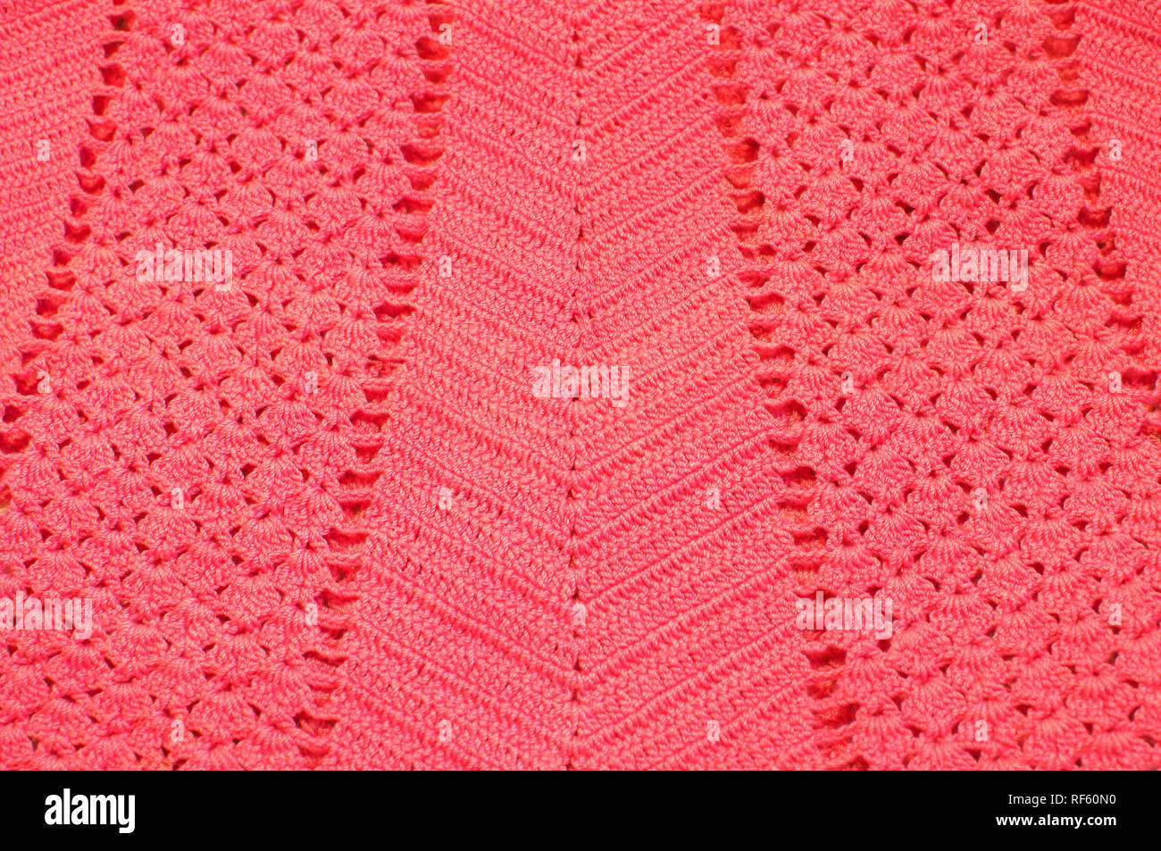 Pattern on a crocheted garment in Living Coral, the colour of the year for 2019. Stock Photo