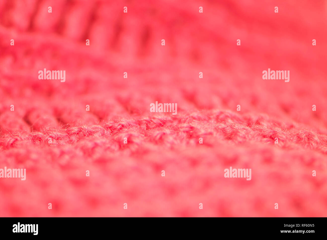 Macro of crocheted yarn in Living Coral, the colour of the year for 2019. Stock Photo