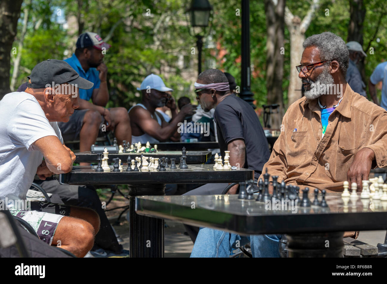 Chess players in Washington Square Park on a bright sunny day, Lower Manhattan, New York City USA Stock Photo