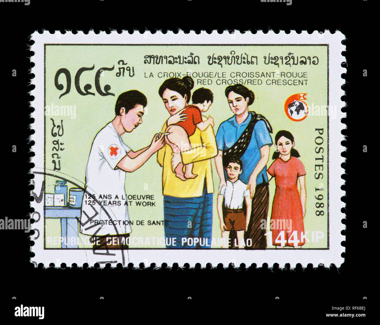 Postage stamp from Laos depicting an infant being immunized, 125th anniversary of the Red Cross and Red Crescent. Stock Photo
