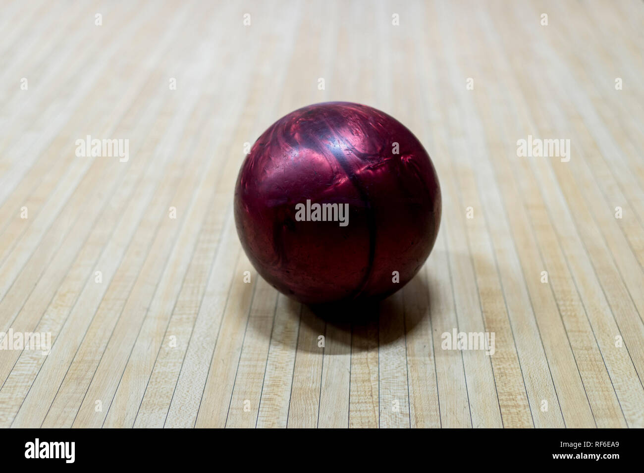 Purple bowling ball on the track in the bowling center Stock Photo