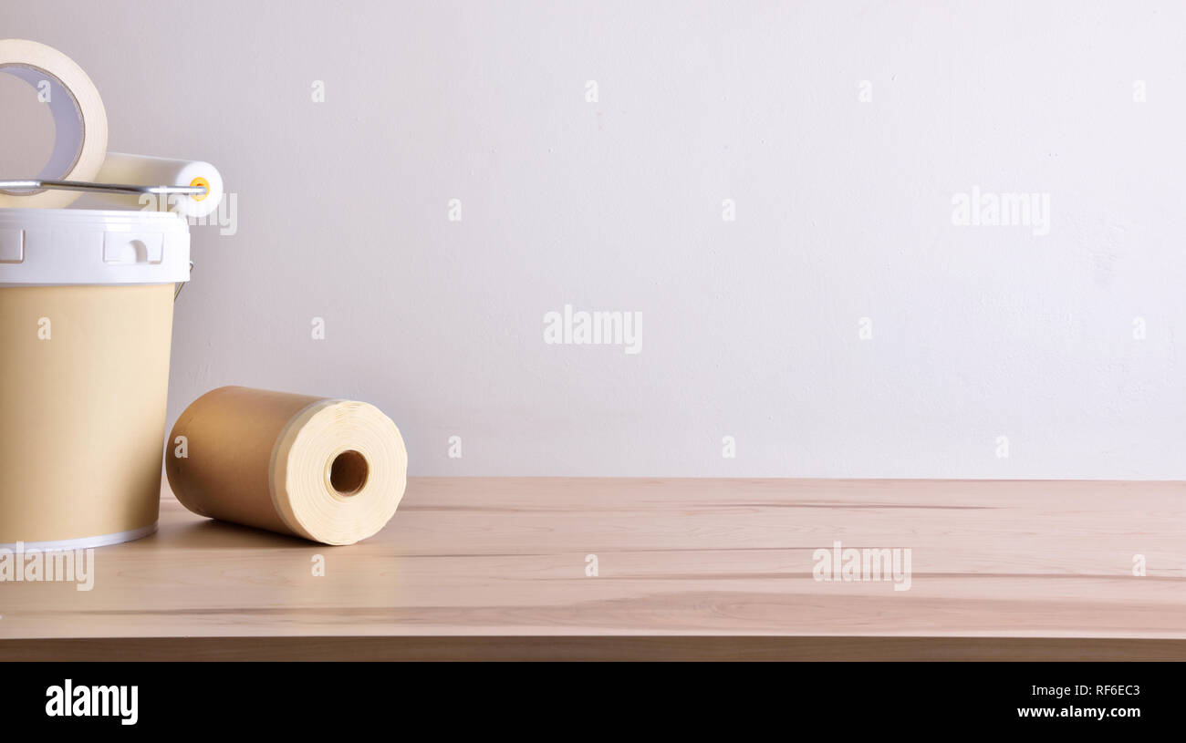 Painting tools for home on table with white wall background. Horizontal composition. Front view. Stock Photo