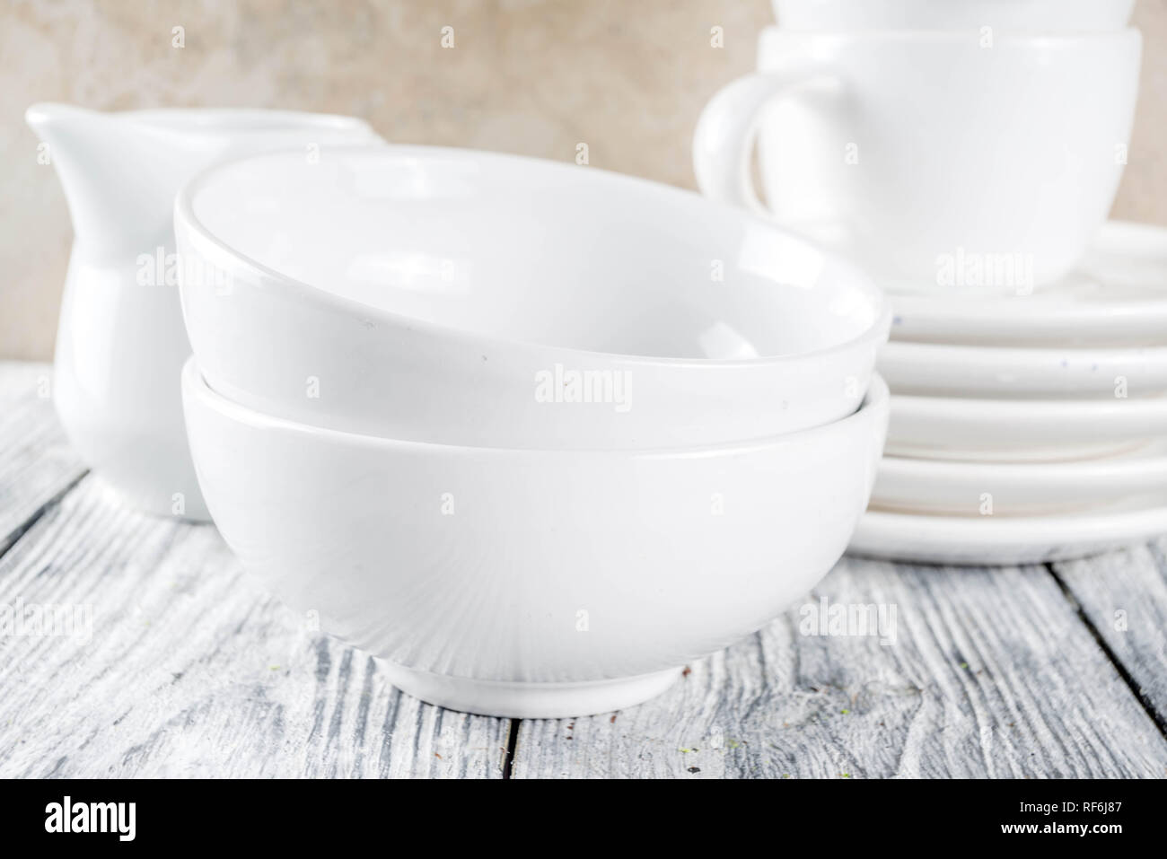 Assortment stack clean empty new white kitchen utensils, plates, bowls