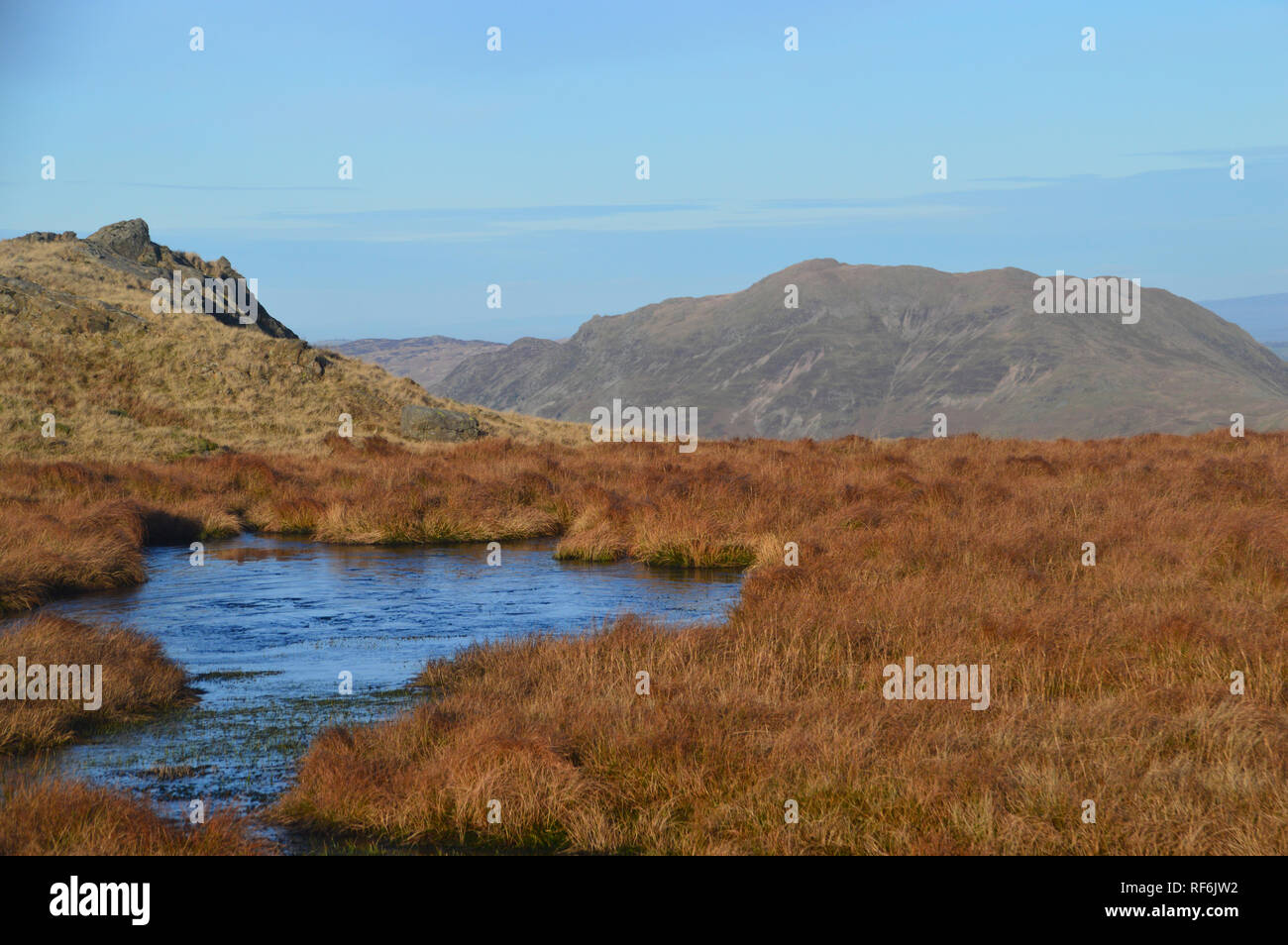 The Wainwright Place Fell from a Small Tarn Black Brow near Little Hart Crag, Lake District National Park, Cumbria, England, UK. Stock Photo