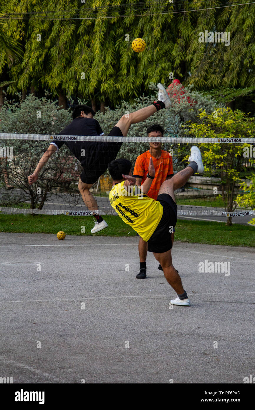 Sepak takraw is a ball game played with a net with some gymnastics moves thrown in. Sepak is the Malay word for kick and takraw is the Thai word for t Stock Photo