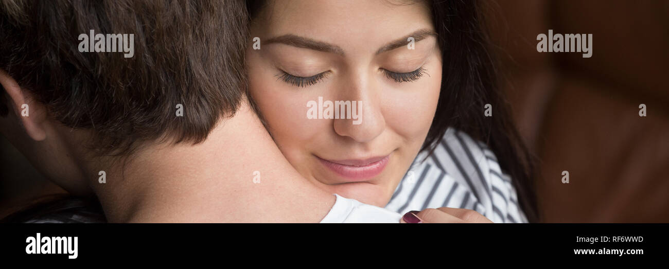 Closeup woman face grateful wife with closed eyes embracing husband Stock Photo