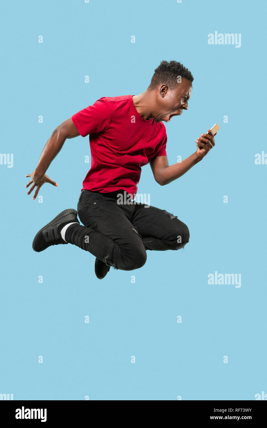 always on mobile. Full length of handsome african young man taking ...
