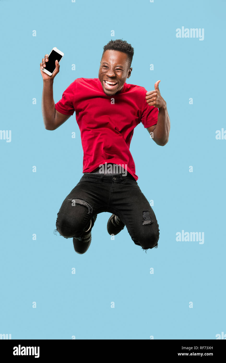always on mobile. Full length of handsome african young man taking ...