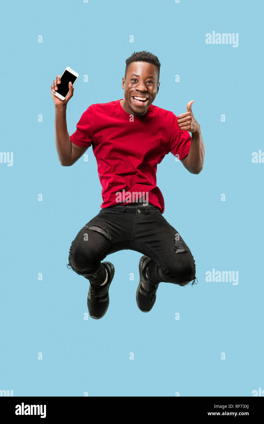 always on mobile. Full length of handsome african young man taking ...