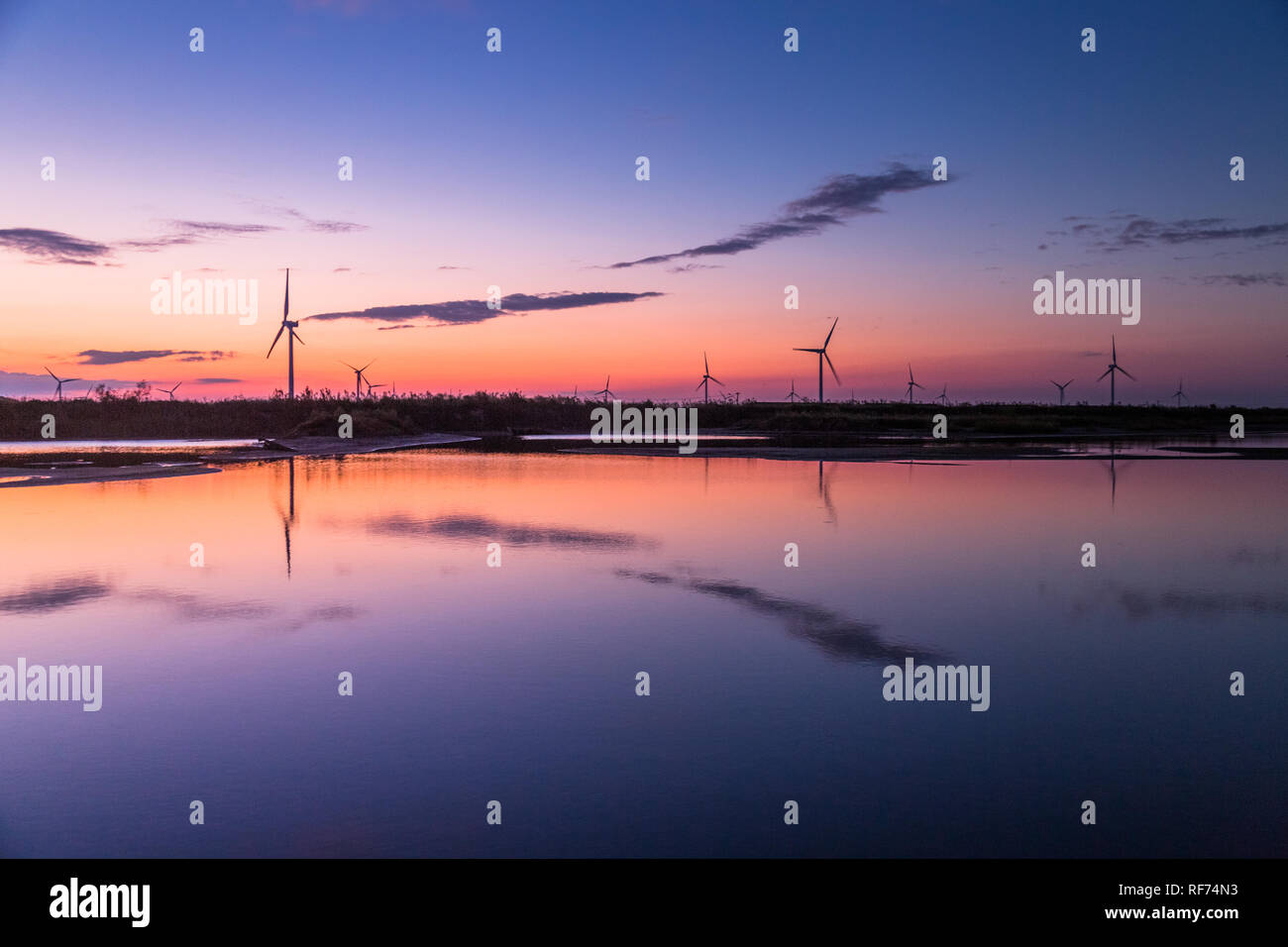 Wind turbines on landscape in sunset Stock Photo - Alamy