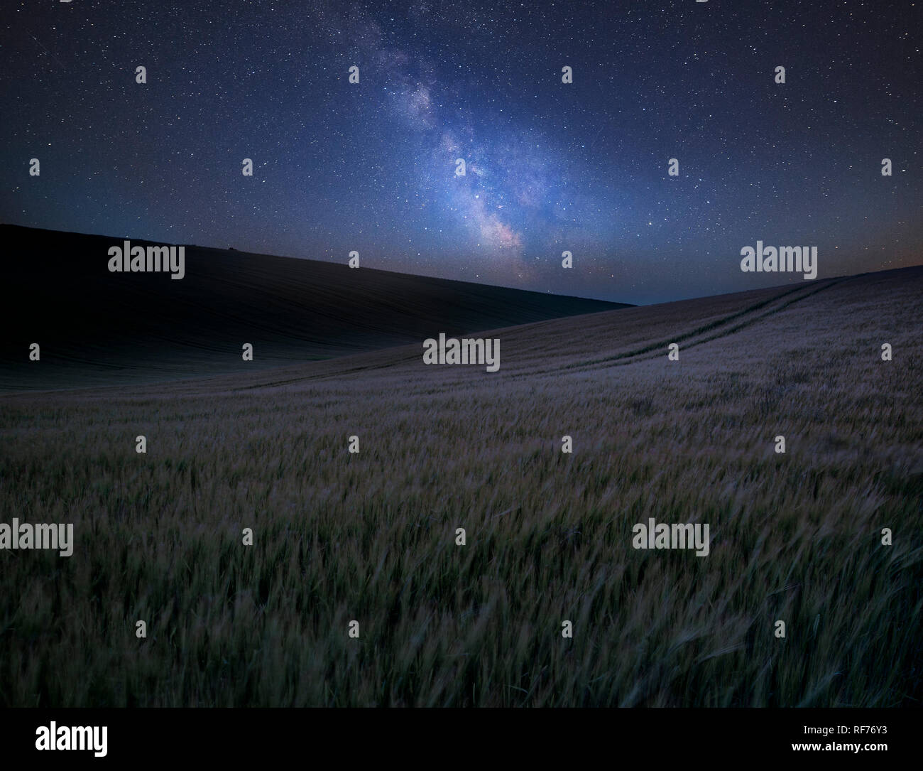 Stunning vibrant Milky Way composite image over landscape of field of ...