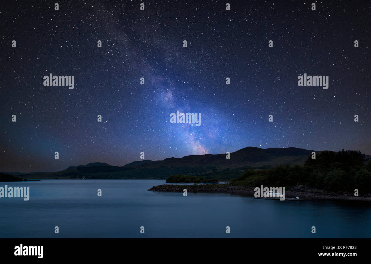 Stunning vibrant Milky Way composite image over landscape of calm lake ...