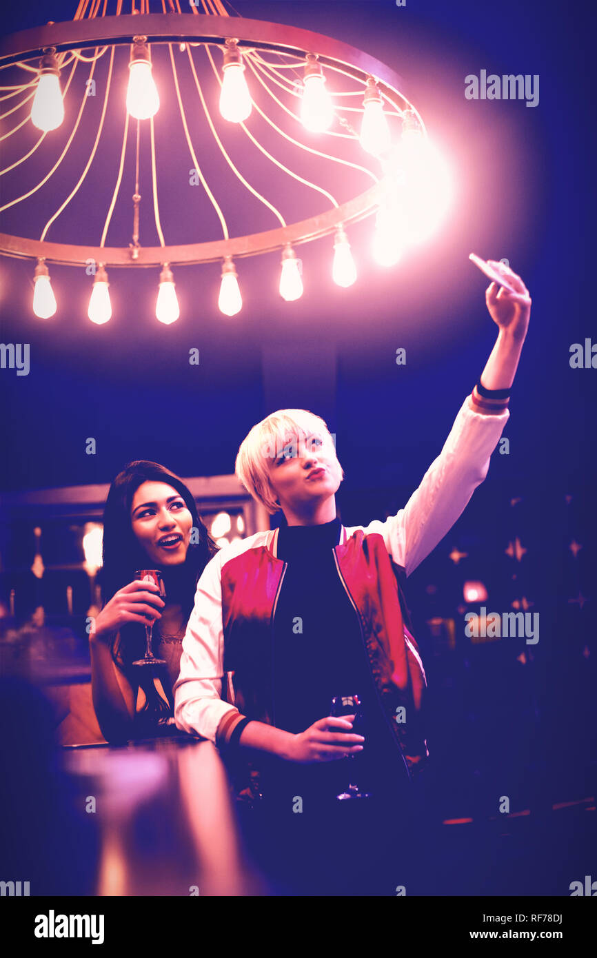 Smiling friends taking a selfie while having wine Stock Photo