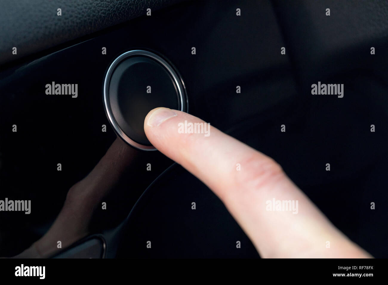 Finger pressing a button in a car Stock Photo