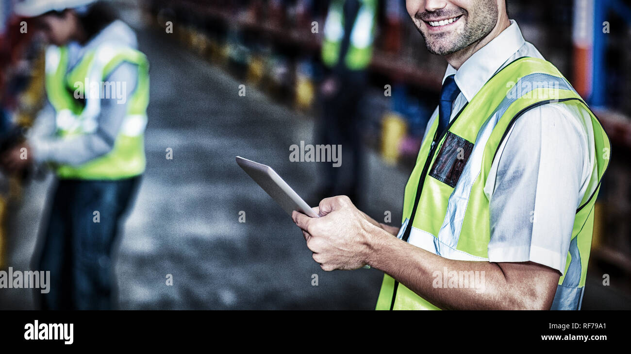 Worker in warehouse looking at camera Stock Photo