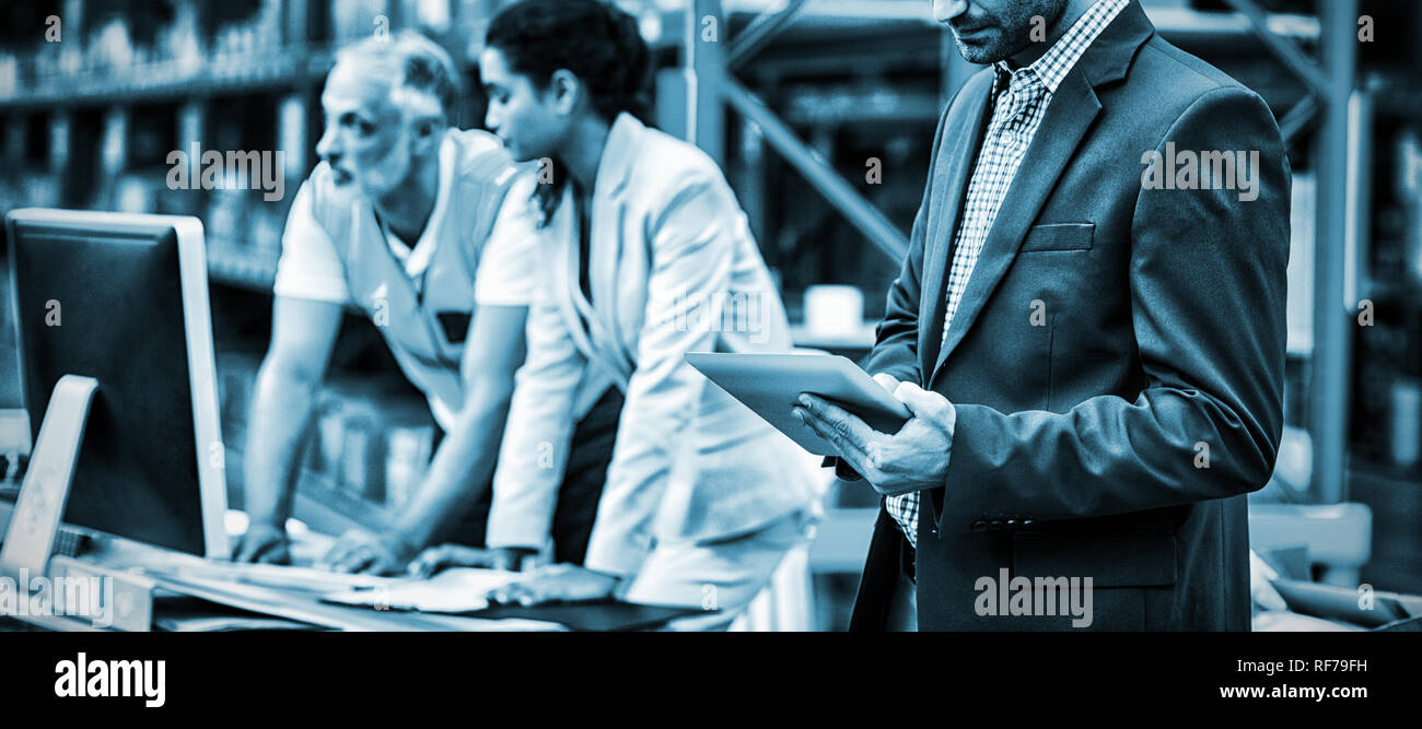 Warehouse managers and worker working together Stock Photo