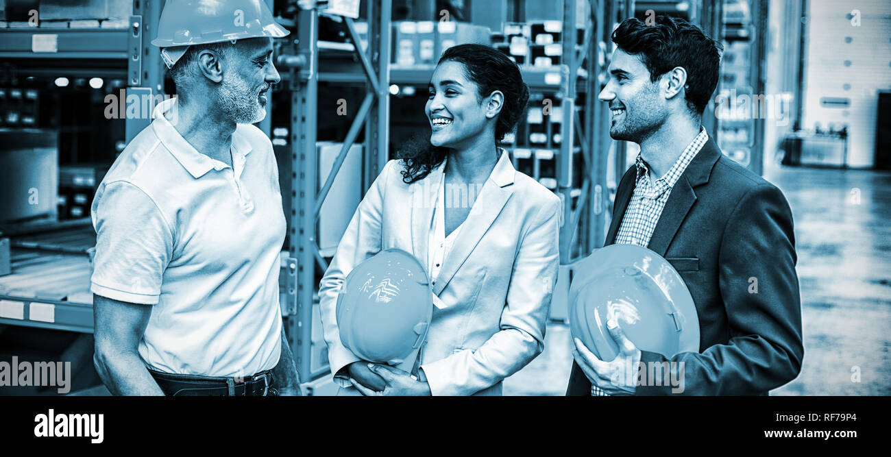 Happy warehouse managers and worker standing together Stock Photo