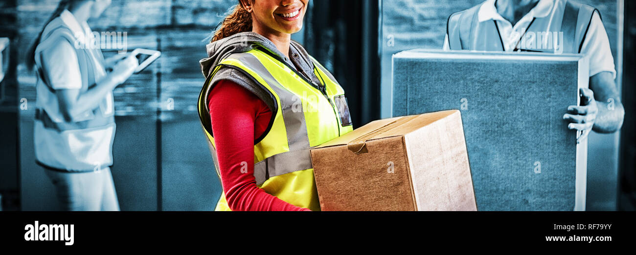 Worker is holding goods and smiling to the camera Stock Photo