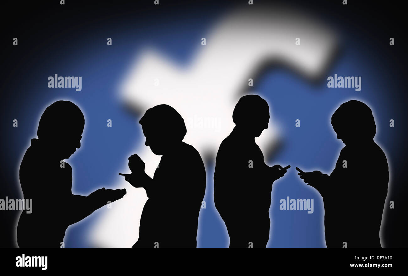 Silhouettes of 4 people using the Facebook app on smartphones to communicate with each other on Social Media. Social networking. Stock Photo