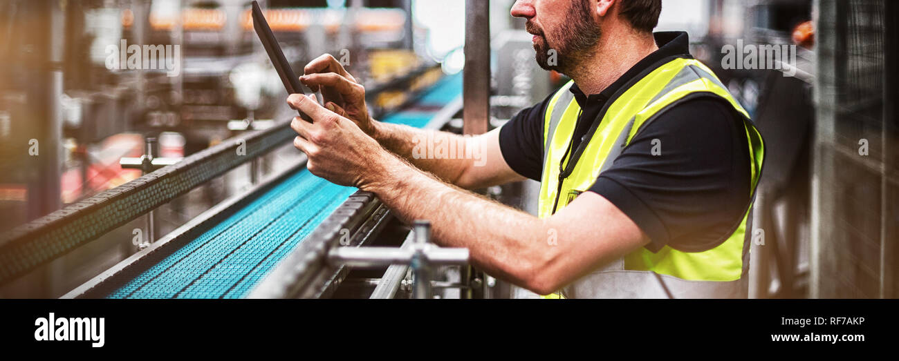Factory worker using a digital tablet in factory Stock Photo