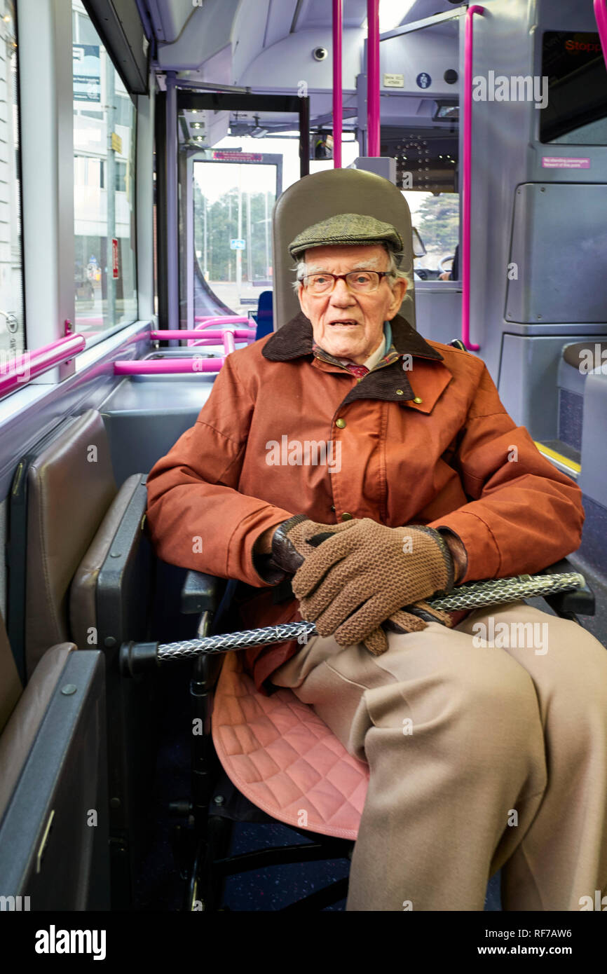 Man in his late eighties in a wheelchair travelling to his local hospital in Portsmouth by bus Stock Photo
