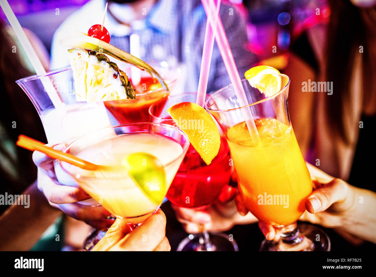 Group of friends toasting cocktail at bar counter Stock Photo