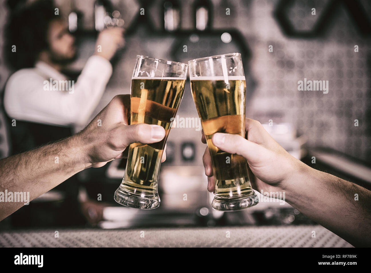 Cropped image of men toasting beer glass Stock Photo