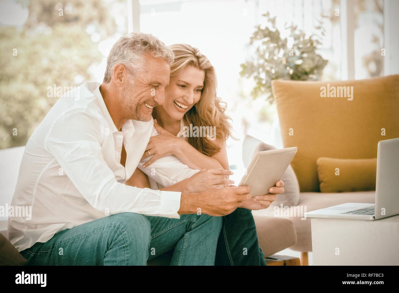 Smart mature couple using digital tablet Stock Photo
